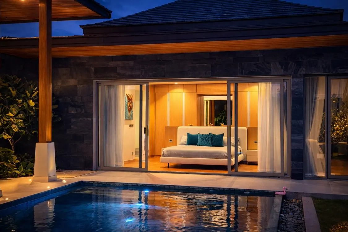 Bedroom opening to the pool at dusk