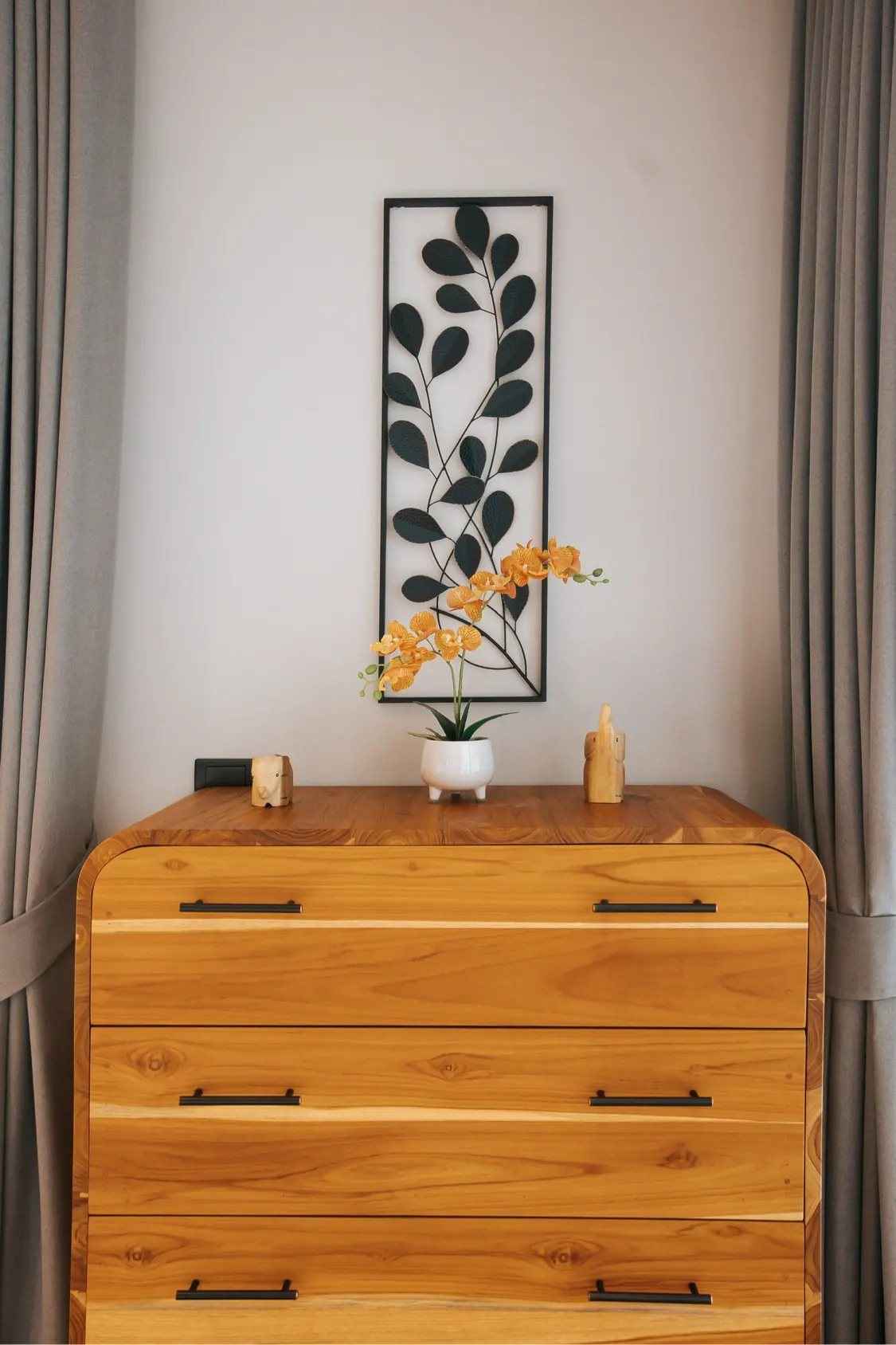 Wood dresser with orchid and elephant figurines